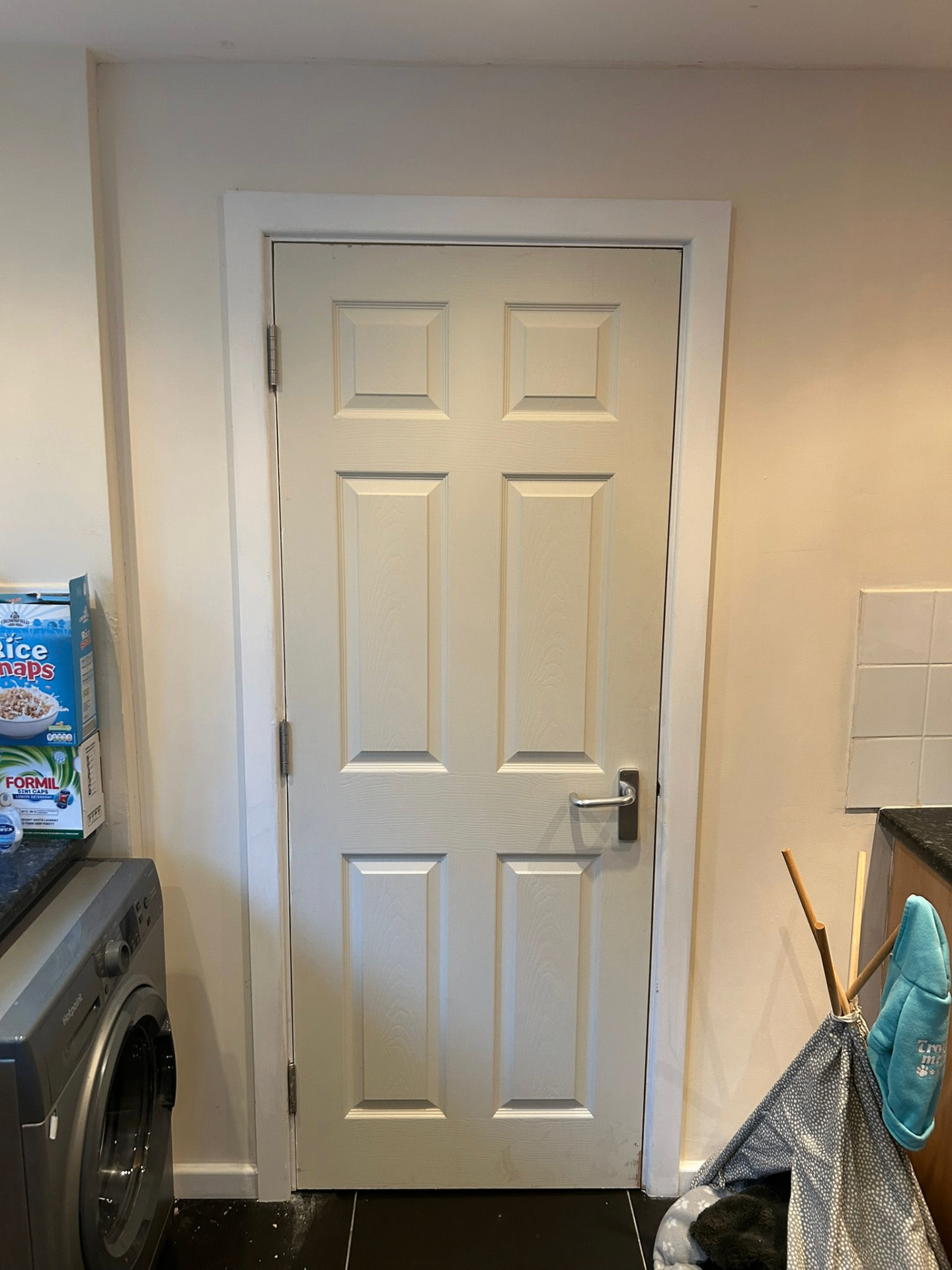White six-panel certified fire door installed in a Merseyside residential utility room by D2 Joinery